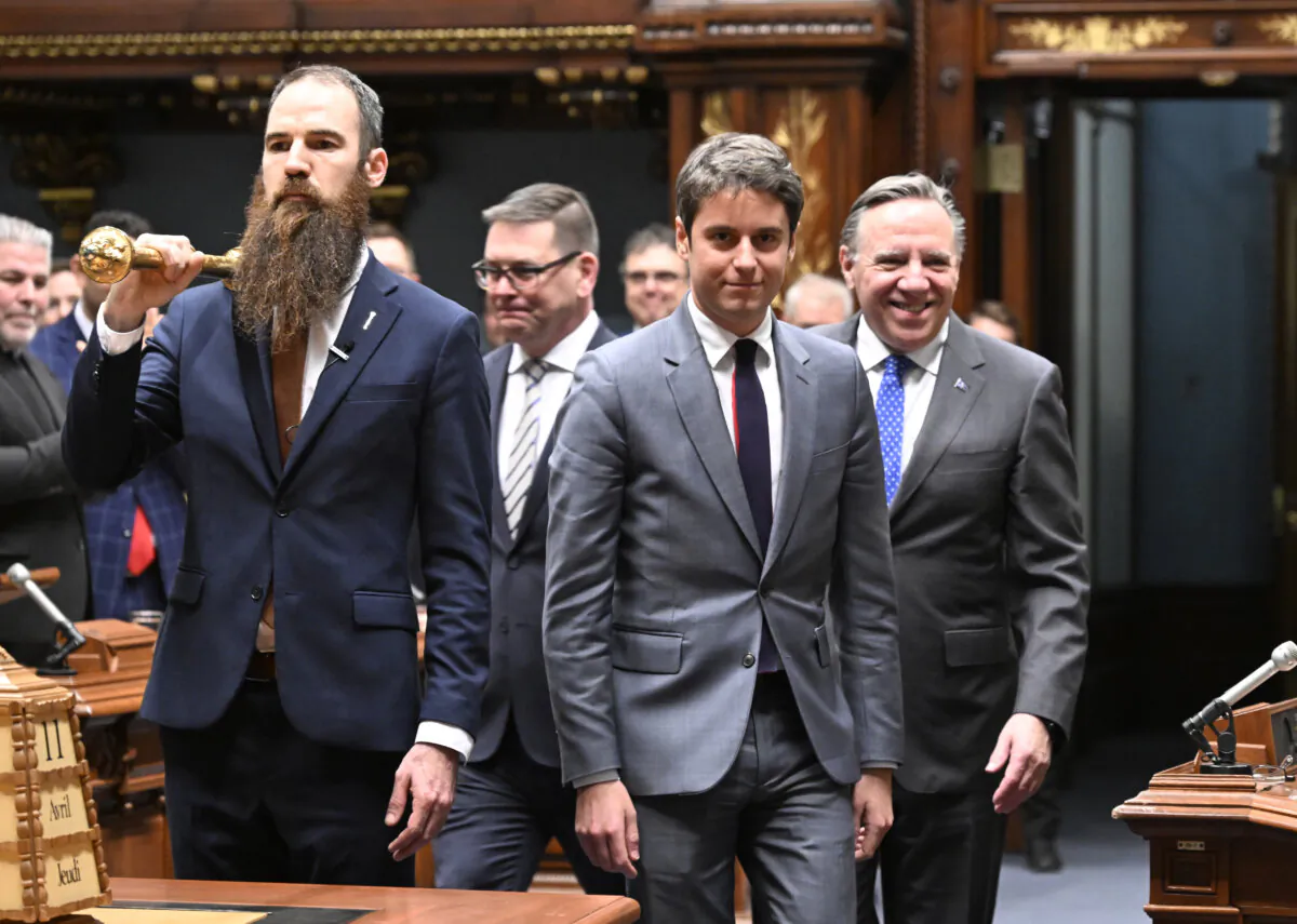 The Prime Minister of France Gabriel Attal (C) walks in the Salon Bleu of the National Assembly, followed by Quebec Premier Francois Legault (R), at the legislature in Quebec City, on April 11, 2024. (The Canadian Press/Jacques Boissinot)