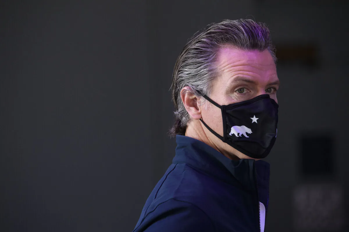 California Gov. Gavin Newsom wears a face mask as he prepares to give a briefing after touring a COVID-19 vaccination site in Long Beach, Calif., on Feb. 22, 2021. (Patrick T. Fallon/AFP/Getty Images)