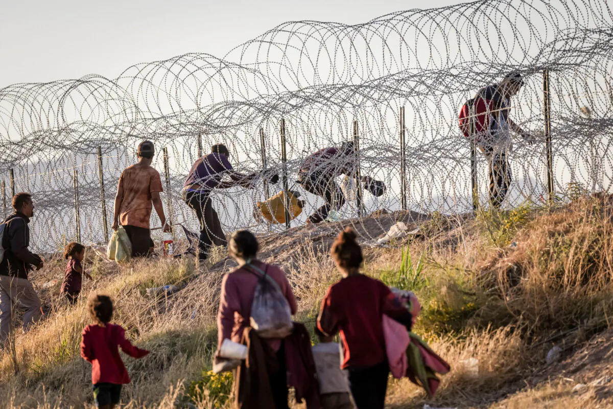 Illegal immigrants cross into the United States from Mexico to be processed by Border Patrol agents in El Paso, Texas, on May 8, 2023. (John Moore/Getty Images)