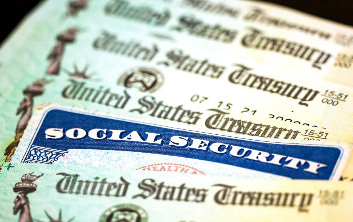 A Social Security card sits alongside checks from the U.S. Treasury in Washington on Oct. 14, 2021. (Kevin Dietsch/Getty Images)