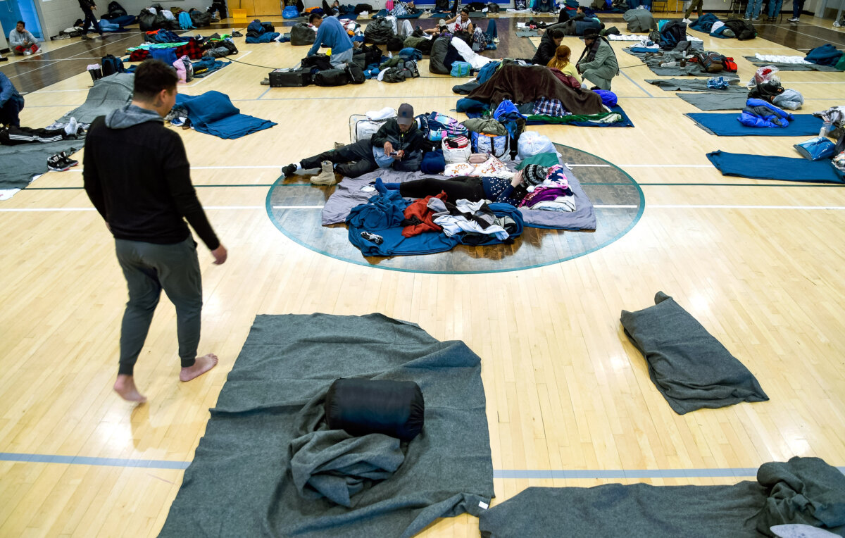 Illegal immigrants rest at a makeshift shelter in Denver, Colo., on Jan. 6, 2023. Denver Mayor Mike Johnston announced a major shift on April 10, 2024, in the city's response to the migrant crisis, extending support to six months but with only 1,000 spaces. (Thomas Peipert/AP Photo)