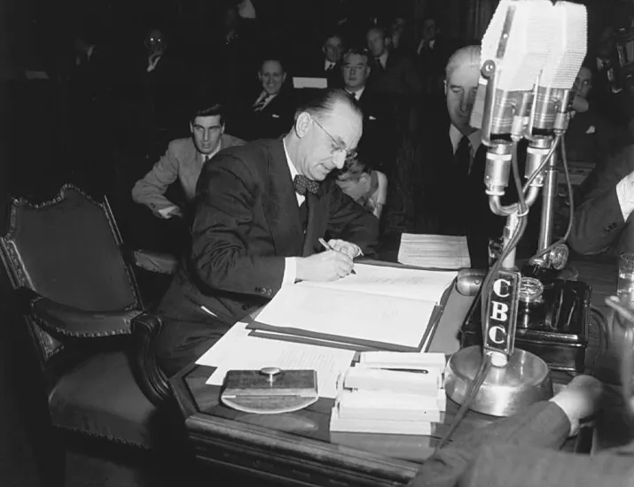Joey Smallwood signs the agreement which brought Newfoundland into Canada on Dec. 11, 1948. (Public Domain)