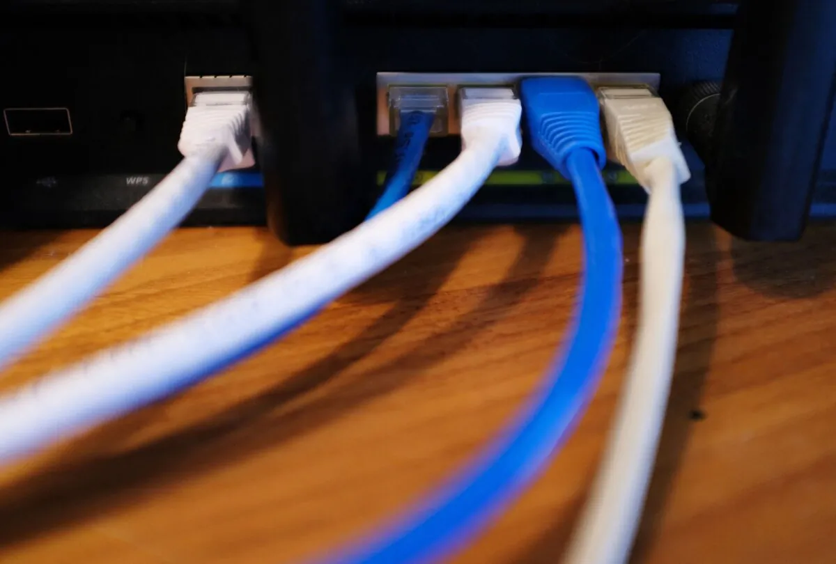 Ethernet cables are seen running from the back of a wireless router in Washington on March 21, 2019. (Mandel Ngan/AFP via Getty Images)