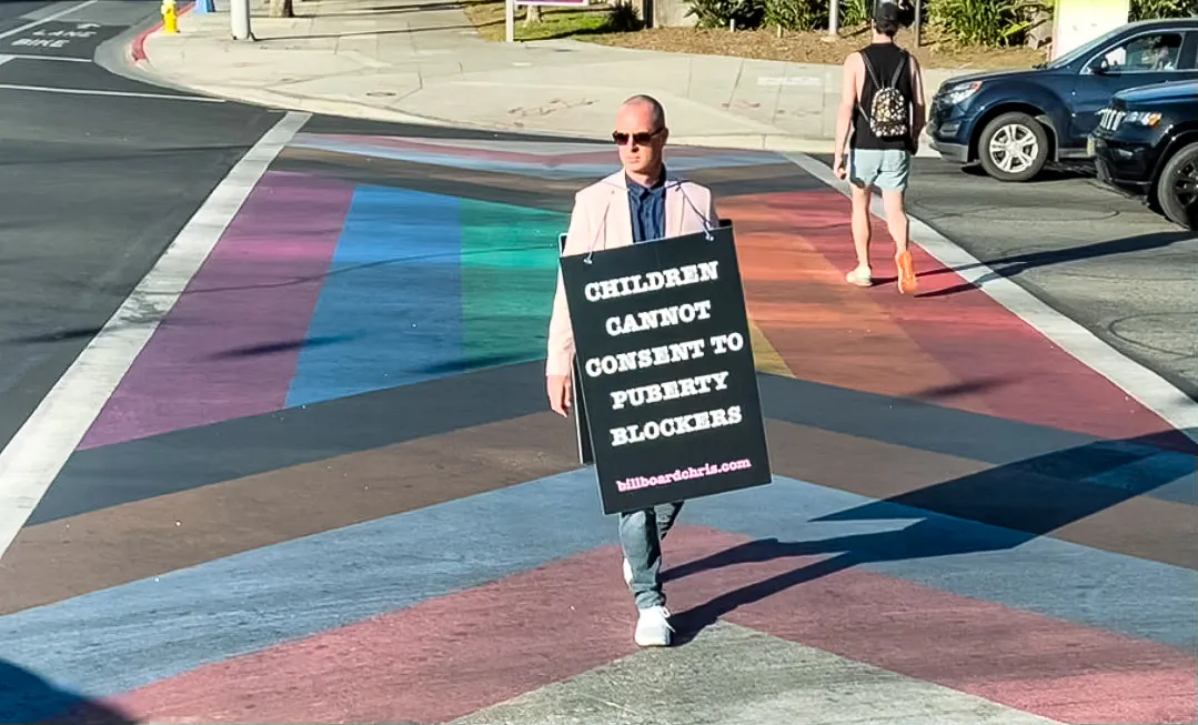 Activist Chris Elton carries a sign reading "Children Cannot Consent to Puberty Blockers" through West Hollywood, Calif., in 2022. (Courtesy of Billboard Chris)