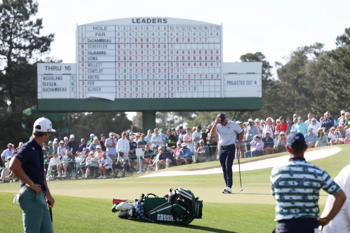 Bryson DeChambeau of the United States shields himself from the wind on the 17th green during the second round of the 2024 Masters Tournament at Augusta National Golf Club in Augusta, Georgia, on April 12, 2024. (Jamie Squire/Getty Images)