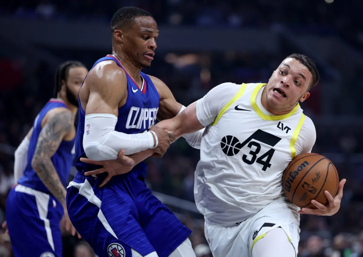 Kenneth Lofton Jr. (34) of the Utah Jazz reacts as he is fouled by Russell Westbrook (0) of the LA Clippers during the first half in Los Angeles on April 12, 2024. (Harry How/Getty Images)