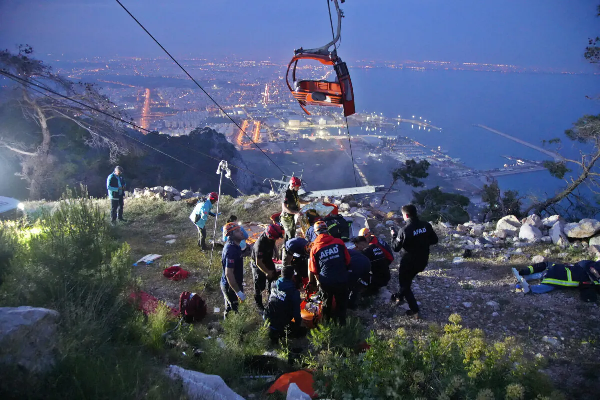 Members of Turkey's Disaster Management Authority (AFAD) take part in a rescue operation after a cable car cabin collided with a broken pole, in Antalya, Turkey, on April 12, 2024. (Ihlas News Agency via Reuters)