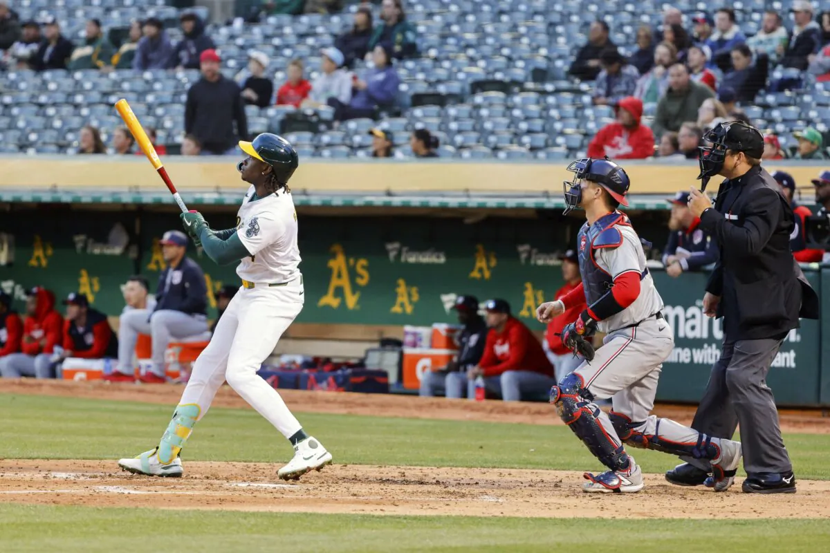 Oakland Athletics' Lawrence Butler hits a solo home run in the third inning of a baseball game as Washington Nationals catcher Riley Adams watches,  in Oakland, Calif., on April 12, 2024. (Santiago Mejia/San Francisco Chronicle via AP)