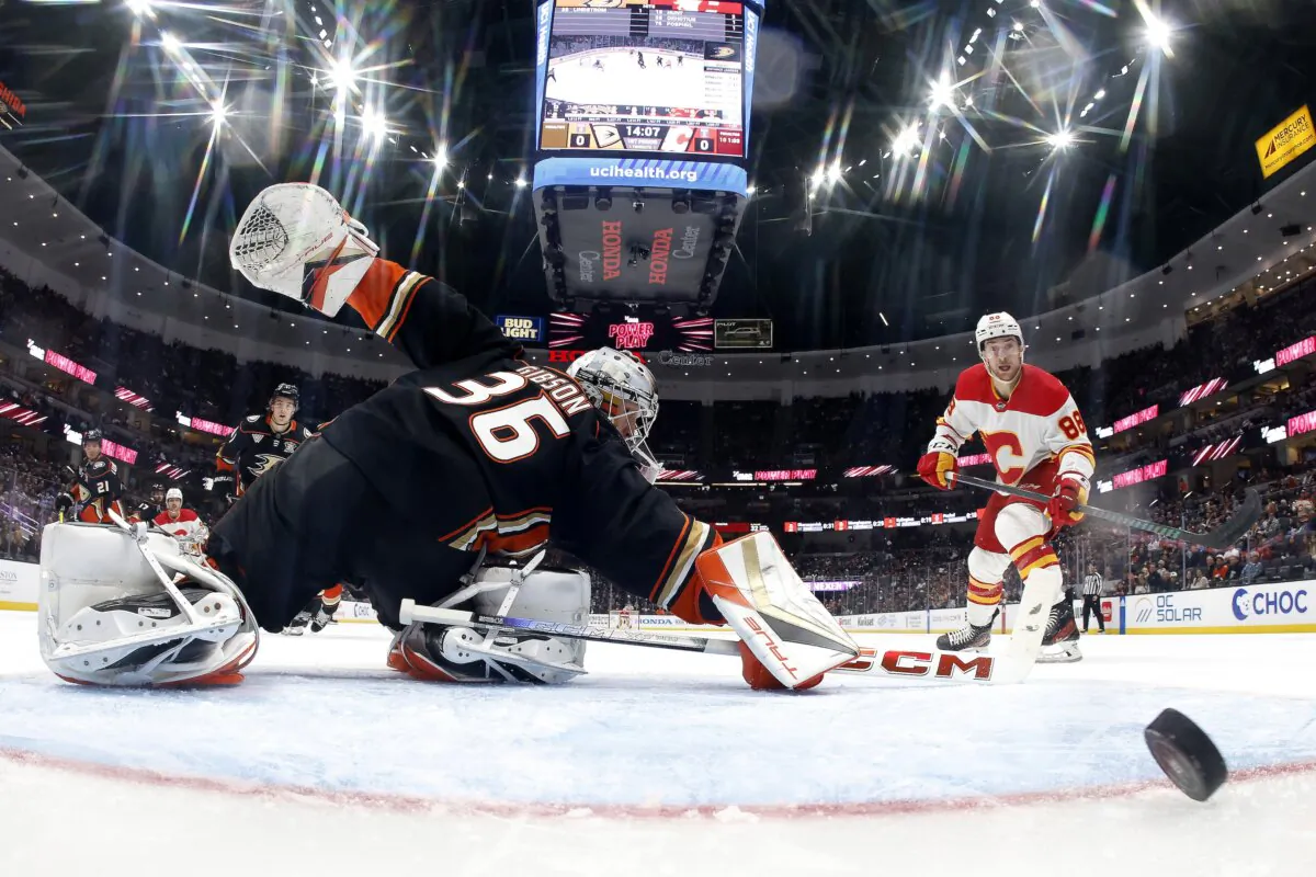 John Gibson (36) of the Anaheim Ducks is unable to stop a goal by Andrei Kuzmenko (96) as Andrew Mangiapane (88) of the Calgary Flames looks on during the first period of a game at in Anaheim, Calif., on April 12, 2024. (Sean M. Haffey/Getty Images)