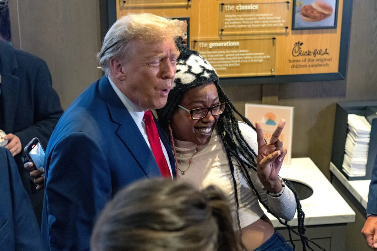 Former President Donald Trump hugs supporter Michaelah Montgomery (R) at a Chick-fil-A restaurant in Atlanta, Ga., on April 10, 2024. (Megan Varner/Getty Images)