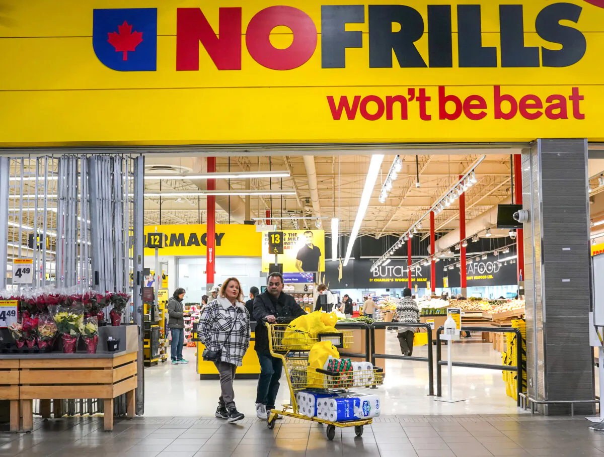 Customers leave a No Frills grocery store in Toronto on November 23, 2023. (The Canadian Press/Chris Young)
