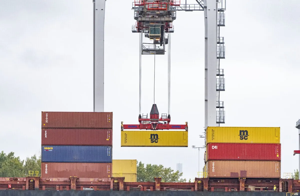 A shipping container is loaded onto a container ship in the Port of Montreal on Sept.19, 2023. (The Canadian Press/Christinne Muschi)