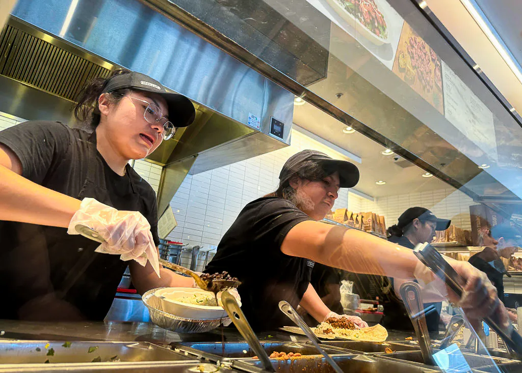 Workers fill food orders at a Chipotle restaurant in San Rafael, Calif., on April 1, 2024. (Justin Sullivan/Getty Images)