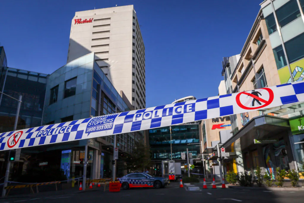 Police tape can be seen in front of a roadblock outside the Westfield Bondi Junction shopping mall in Sydney, Australia on April 14, 2024. (David Gray/AFP via Getty Images)