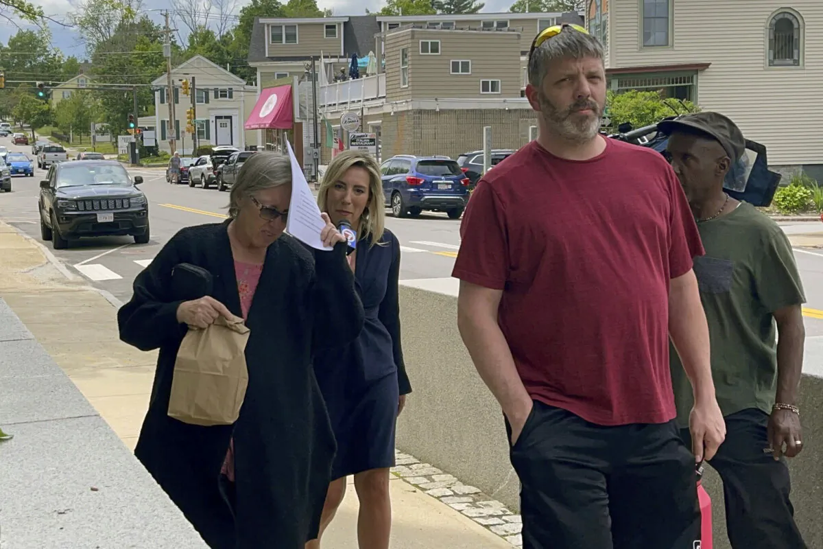 Denise Lodge (L) covers her face as she walks from the federal courthouse in Concord, N.H., on June 14, 2023. (Steven Porter/The Boston Globe via AP, File)