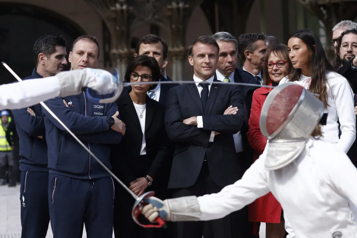 French President Emmanuel Macron (C), French Fencing champion Sara Balzer (R), Minister of Culture of France Rachida Dati (C-L), and Paris' counsellor Brigitte Kuster (2nd R) during his visit to Le Grand Palais, in Paris on April 15, 2024. (Yoan Valat/Pool/AFP via Getty Images)