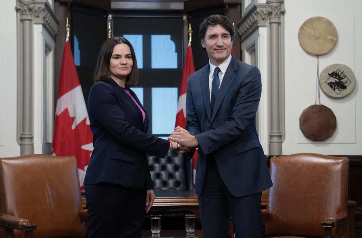 Prime Minister Justin Trudeau and Belarus opposition leader Sviatlana Tsikhanouskaya pose for cameras as they shake hands before a meeting in Ottawa, on April 15, 2024. (The Canadian Press/Adrian Wyld)