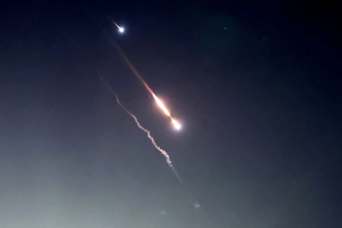 Objects in the sky above Jerusalem after Iran launched drones and missiles toward Israel in Jerusalem on April 14, 2024. (Ronen Zvulun/Reuters)