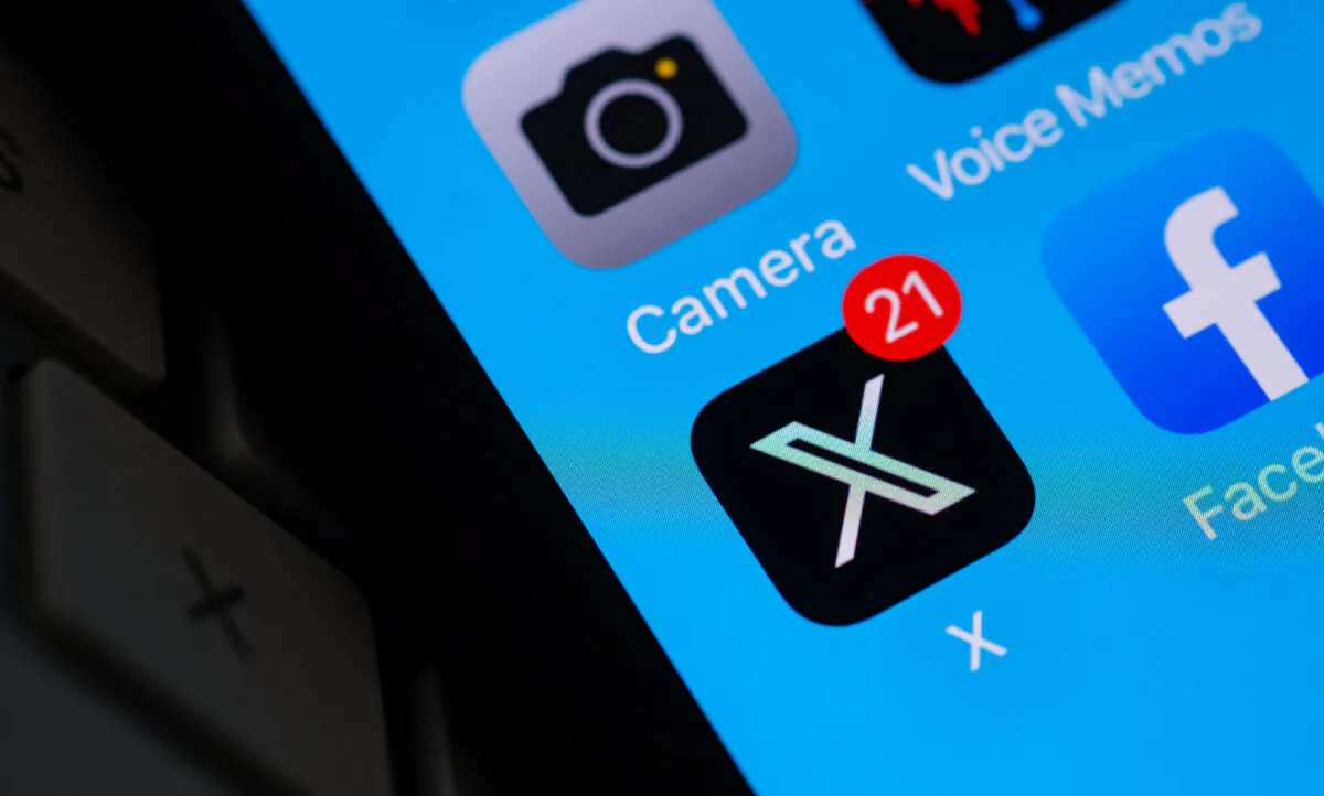 The X logo on a smartphone screen in Los Angeles, Calif., on July 31, 2023. (Chris Delmas/AFP via Getty Images)
