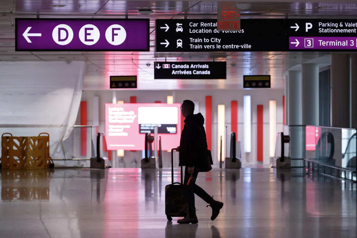 Travellers make their way through Pearson International Airport in Toronto on Nov. 14, 2022. (The Canadian Press/Cole Burston)