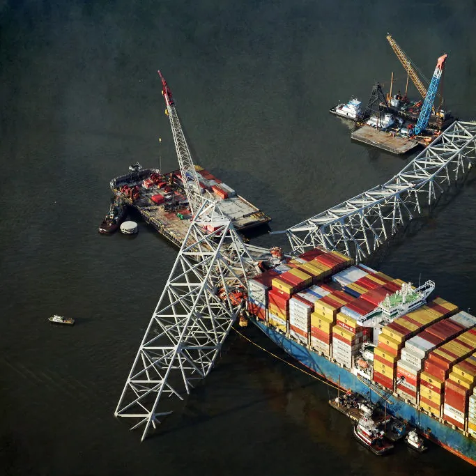 In an aerial view, salvage crews use a crane to remove wreckage from the cargo ship Dali after it struck and collapsed the Francis Scott Key Bridge in Baltimore, shown on April 9, 2024. (Kevin Dietsch/Getty Images)
