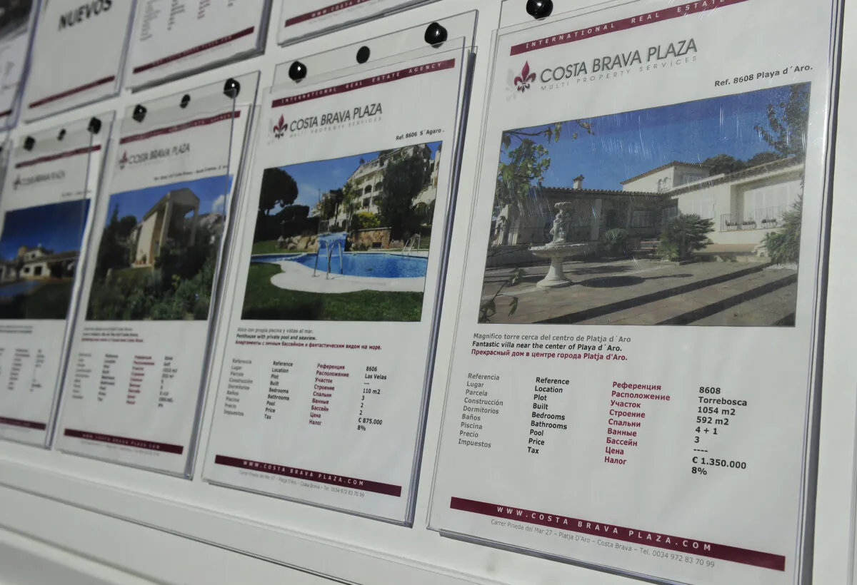 For sale signs written in Russian are displayed on the window of a real estate agency in Platja d'Aro, Spain on March 18, 2013. (Josep Lago/AFP via Getty Images)