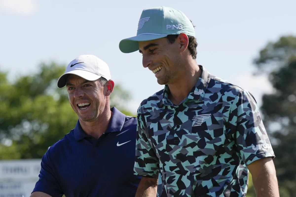 PGA's Rory McIlroy (L) of Northern Ireland, and LIV Golf's Joaquin Niemann, of Chile, walks off the 18th hole after final round at the Masters golf tournament at Augusta National Golf Club in Augusta, Georgia, on April 14, 2024. (David J. Phillip/AP Photo)