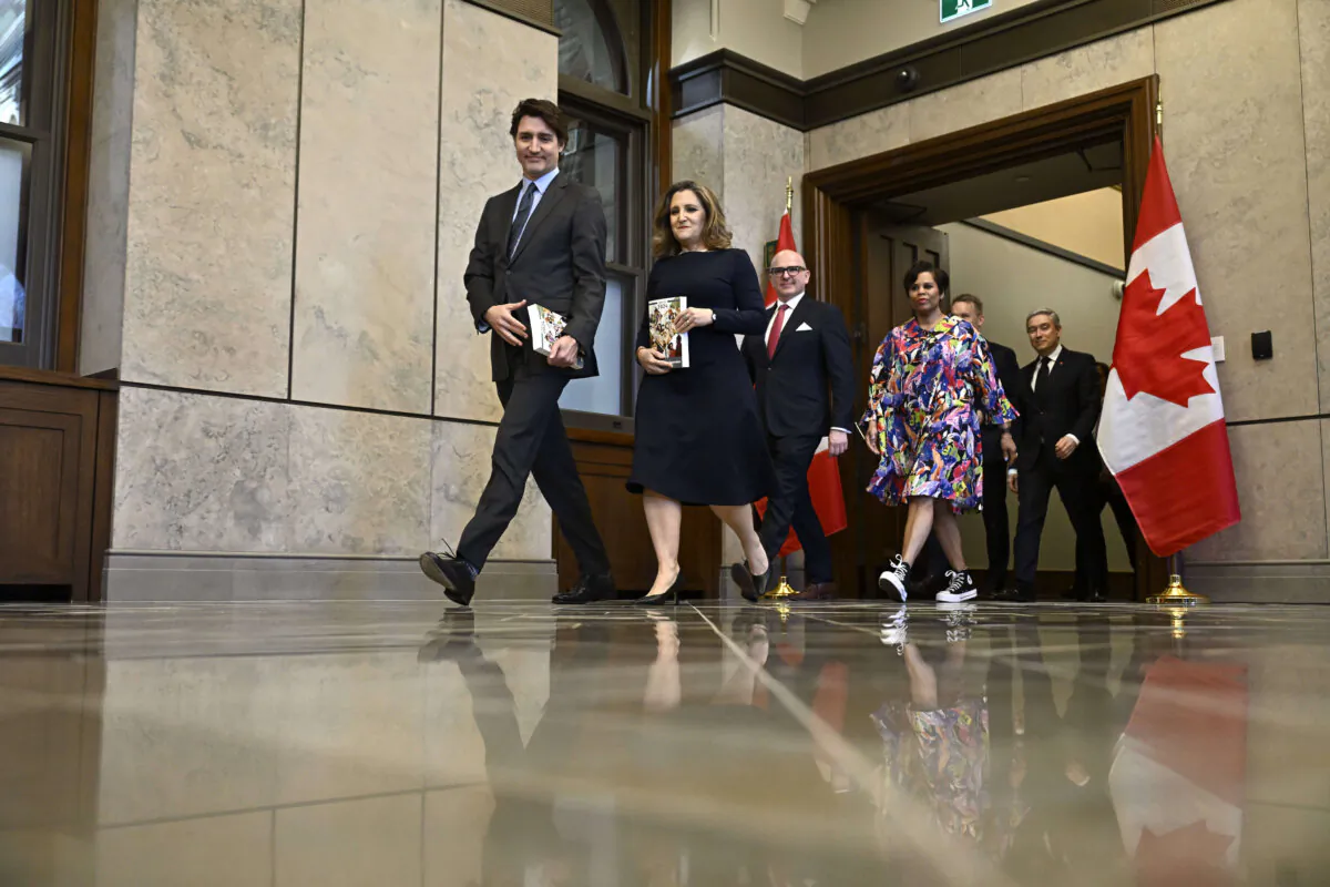 Prime Minister Justin Trudeau and Deputy Prime Minister and Minister of Finance Chrystia Freeland are joined by cabinet ministers for a photo before the tabling of the federal budget on Parliament Hill in Ottawa on April 16, 2024. (The Canadian Press/Justin Tang)