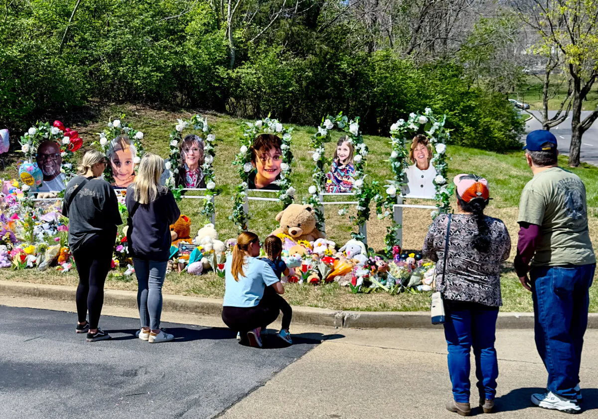 Mourners observe the makeshift memorial at The Covenant School in the Green Hills neighborhood of Nashville, Tenn., on March 31, 2023, four days after six were killed at the school in a shooting. (Chase Smith/The Epoch Times)