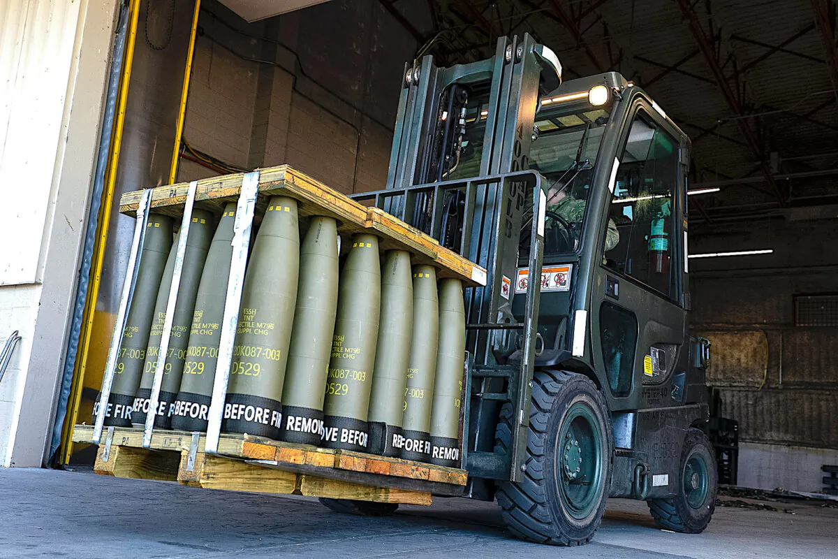 Airmen with the 436th Aerial Port Squadron use a forklift to move 155 mm shells ultimately bound for Ukraine, at Dover Air Force Base, Del., on April 29, 2022. (Alex Brandon/AP Photo)