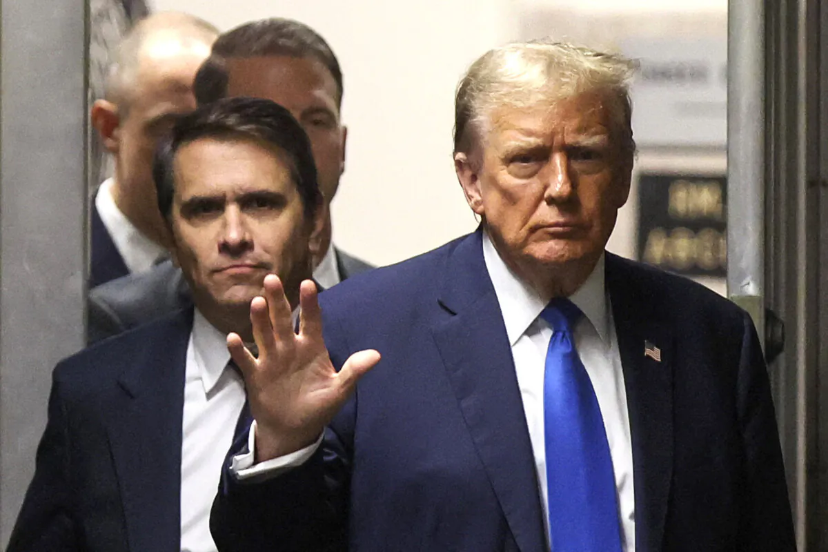 Former President Donald Trump gestures as he returns from a recess in his trial for allegedly covering up hush money payments linked to extramarital affairs, at Manhattan Criminal Court in New York City on April 18, 2024. (Brendan McDermid/Pool/AFP via Getty Images)
