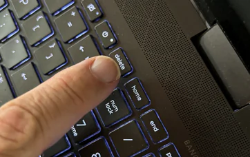 A finger poised over the delete key on a computer keyboard in this undated file photo. (Patricia Tolson/The Epoch Times).
