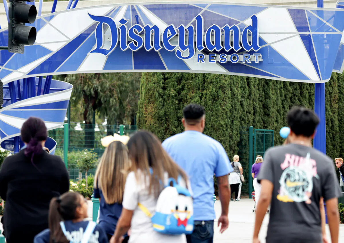 People walk toward an entrance to Disneyland in Anaheim, Calif., on April 24, 2023. (Mario Tama/Getty Images)