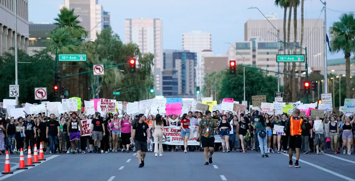 Thousands of protesters march around the Arizona Capitol after the Supreme Court decision to overturn the landmark Roe v. Wade abortion decision on June 24, 2022, in Phoenix. The Supreme Court on Friday stripped away women’s constitutional protections for abortion, a fundamental and deeply personal change for Americans' lives after nearly a half-century under Roe v. Wade. The court’s overturning of the landmark court ruling is likely to lead to abortion bans in roughly half the states. (AP Photo/Ross D. Franklin)