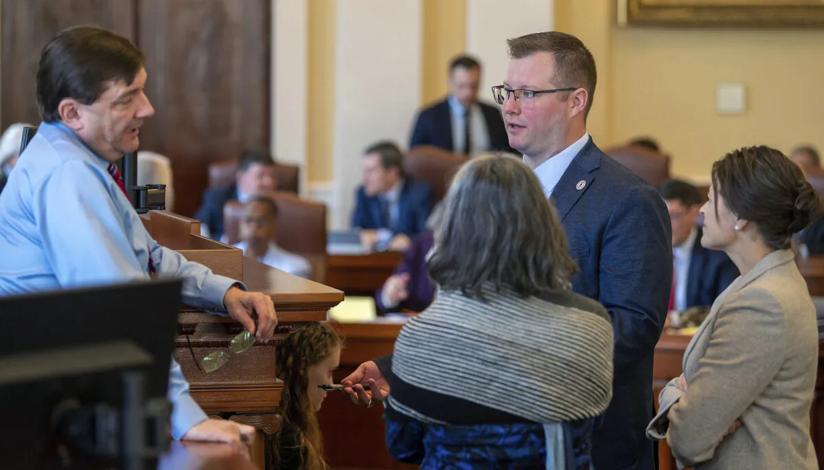 Senate President Troy Jackson (D-Allagash), left, confers with Senate Majority Leader Eloise Vitelli (D-Arrowsic), Senate Minority Leader Sen. Harold "Trey" Stewart (R-Presque Isle), and Assistant Senate Minority Leader Sen. Lisa Keim (R-Dixfield), in front of the rostrum during a break in the morning session at the Maine State House in Augusta, Maine on April 17, 2024. (Joe Phelan/The Kennebec Journal via AP)