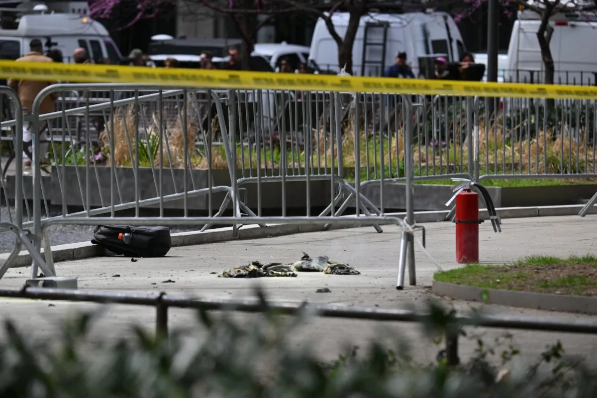 Fire extinguishers (R) are left at the park across from Manhattan Criminal Court in New York City after a man reportedly set himself on fire during the trial of US President Donald Trump, in New York City on April 19, 2024. A man set himself on fire Friday outside the court, New York police said, with officers rushing to extinguish the flames. TV reporters described the scene that unfolded moments after the full panel of 12 jurors and six alternates was selected for the trial of the former president in a hush money cover-up case. (ANGELA WEISS / AFP)