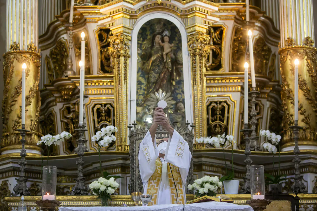 A priest wearing a face mask performs a mass at the Church of Nosso Senhor do Bonfim amidst the coronavirus (COVID-19) pandemic in Salvador, Brazil, on Aug. 13, 2020. (Bruna Prado/Getty Images)