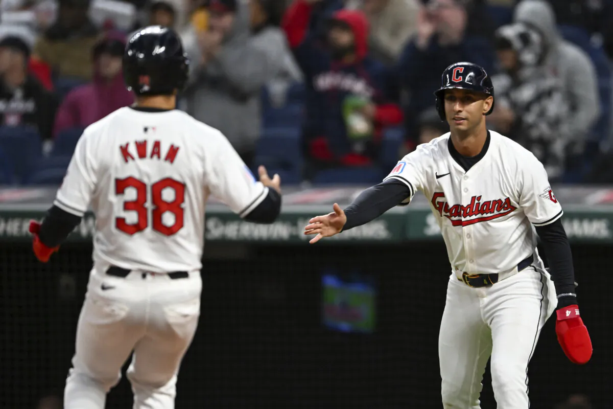 Cleveland Guardians' Steven Kwan (38) and Brayan Rocchio celebrate scoring on a single by Andrés Giménez during the fifth inning of the team's baseball game against the Oakland Athletics in Cleveland on April 19, 2024. (Nick Cammett/AP Photo)