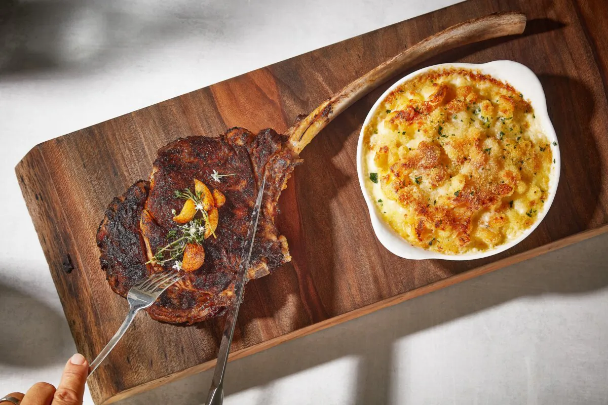 A tomahawk steak (also known as bone-in ribeye) with a side of mac and cheese at CUT by Wolfgang Puck in Beverly Hills, Calif. (Courtesy of Wolfgang Puck Fine Dining Group)
