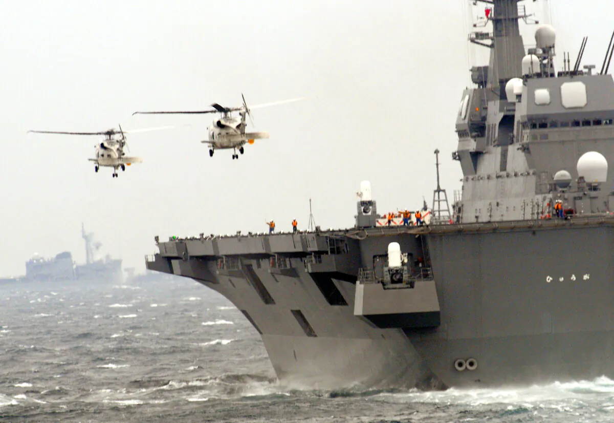 SH-60K patrol helicopters take off from the Japanese DDH Hyuga aircrast carrier during a 2009 fleet review in Sagami Bay, Japan's Kanagawa prefecture, on Oct. 25, 2009. (Katsumi Kasahara/AFP via Getty Images)