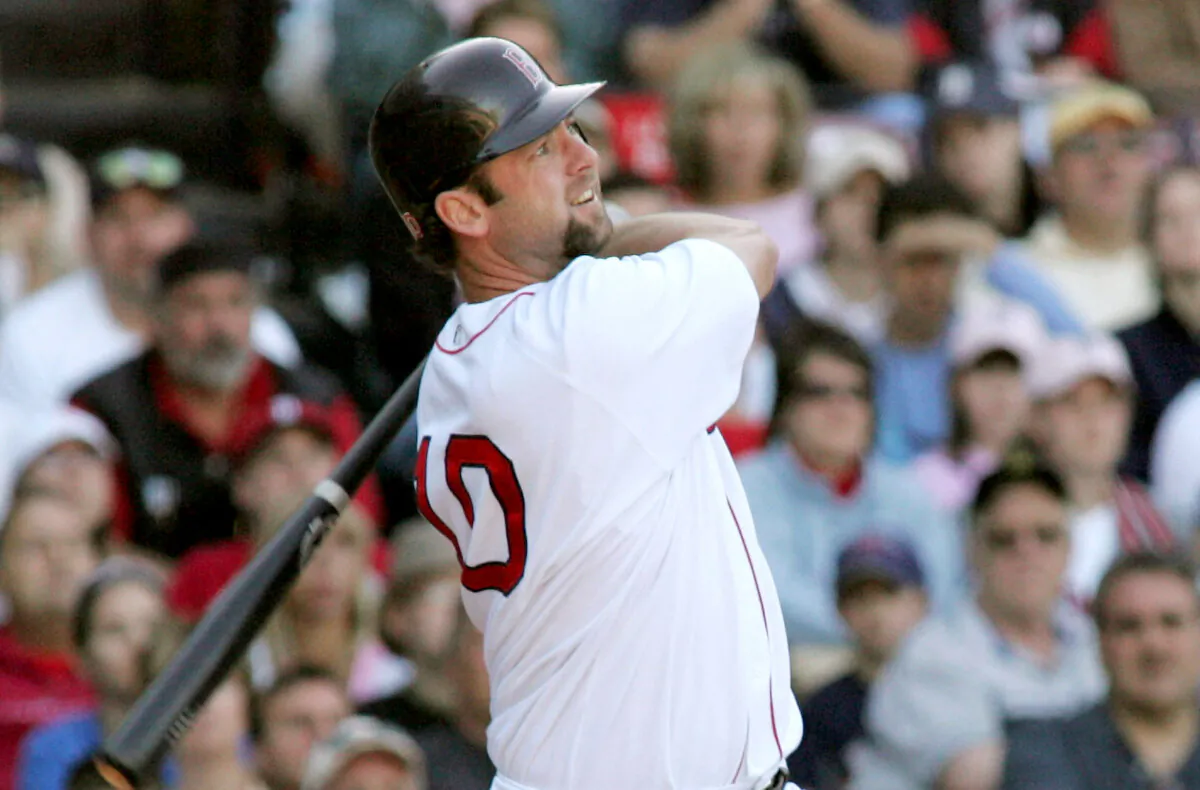 Dave McCarty of the Boston Red Sox watches his game-winning two-run home run, scoring teammate Jason Varitek, to win the game against the Seattle Mariners in the twelfth inning at Boston's Fenway Park, on May 30, 2004. (Jim Bourg JRB/Reuters)