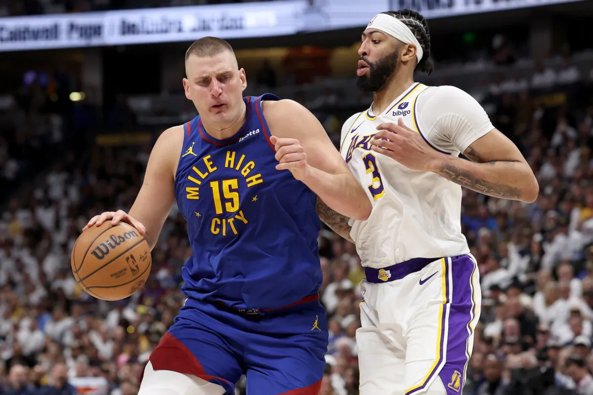 Nikola Jokic (15) of the Denver Nuggets drives against Anthony Davis (3) of the Los Angeles Lakers in the third quarter during game one of the Western Conference First Round Playoffs in Denver on April 20, 2024. (Matthew Stockman/Getty Images)