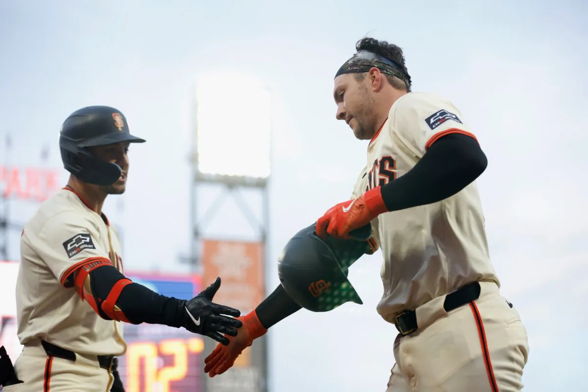 Patrick Bailey (14) of the San Francisco Giants celebrates scoring on a sacrifice fly off the bat of LaMonte Wade Jr. with Michael Conforto (8) in the bottom of the third inning against the Arizona Diamondbacks in San Francisco on April 18, 2024. (Lachlan Cunningham/Getty Images)