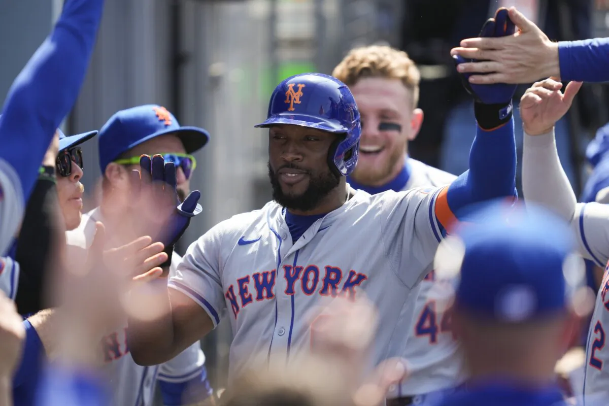 New York Mets' Starling Marte celebrates in the dugout after hitting a home run during the sixth inning of a baseball game against the Los Angeles Dodgers in Los Angeles on April 20, 2024. (Ashley Landis/AP Photo)