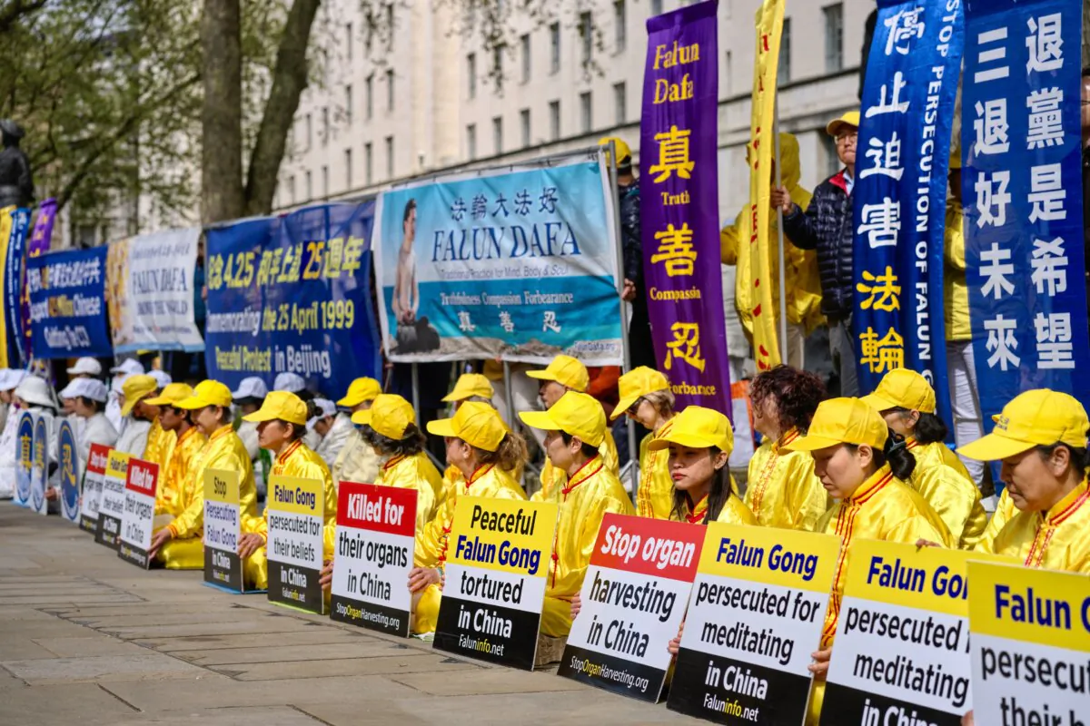 Falun Gong practitioners marking the 25th anniversary of a peaceful demonstration in Beijing, holding banners and placards in London on April 20, 2024. (Yanning Qi/The Epoch Times) 