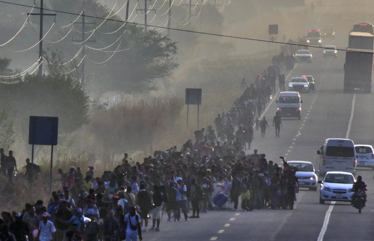 Migrants take part in a caravan toward the border with the United States in Arriaga community, Chiapas State, Mexico, on Jan. 8, 2024. (STR/AFP via Getty Images)