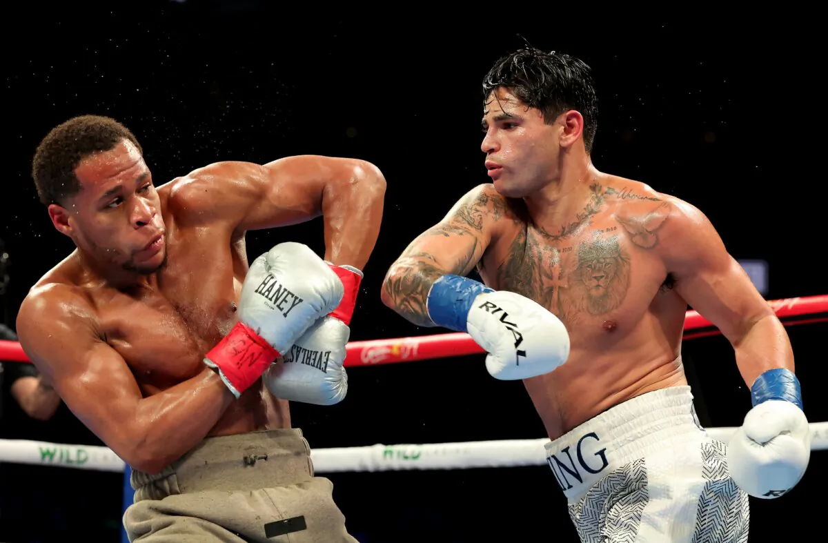 Ryan Garcia (white trunks) punches Devin Haney (gray trunks) during their WBC Super Lightweight title bout in New York on April 21, 2024. (Al Bello/Getty Images)
