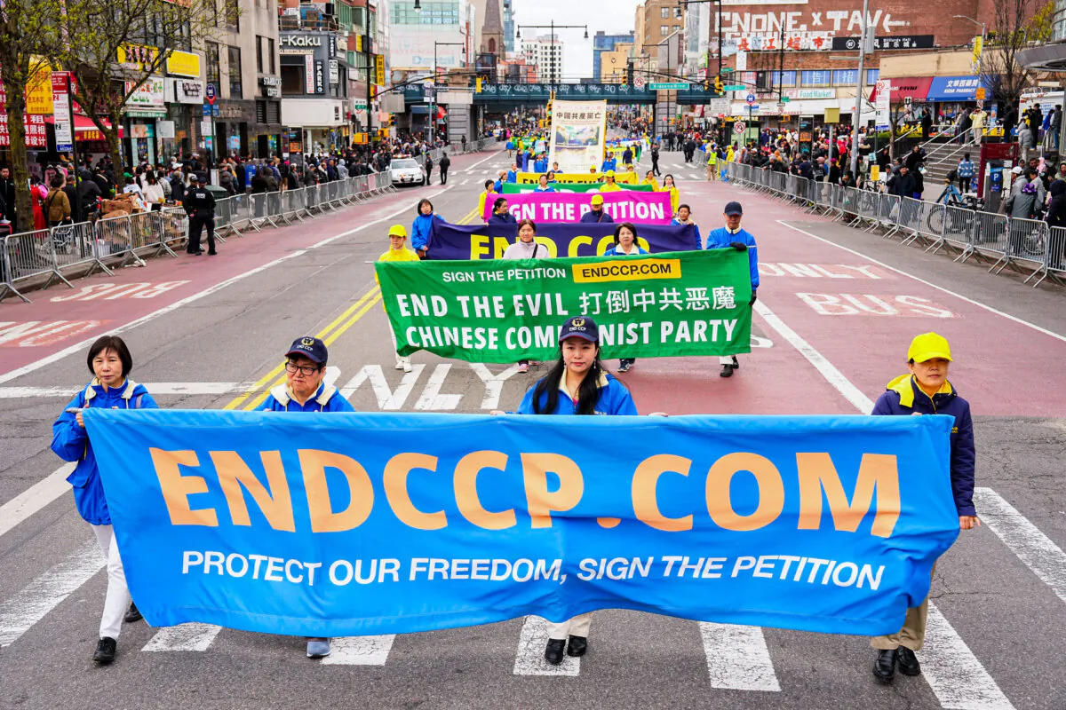 Falun Gong practitioners attend a parade to call for an end to the persecution in China of their faith, in the Flushing neighborhood of Queens, New York, on April 21, 2024. (Larry Dye/The Epoch Times)