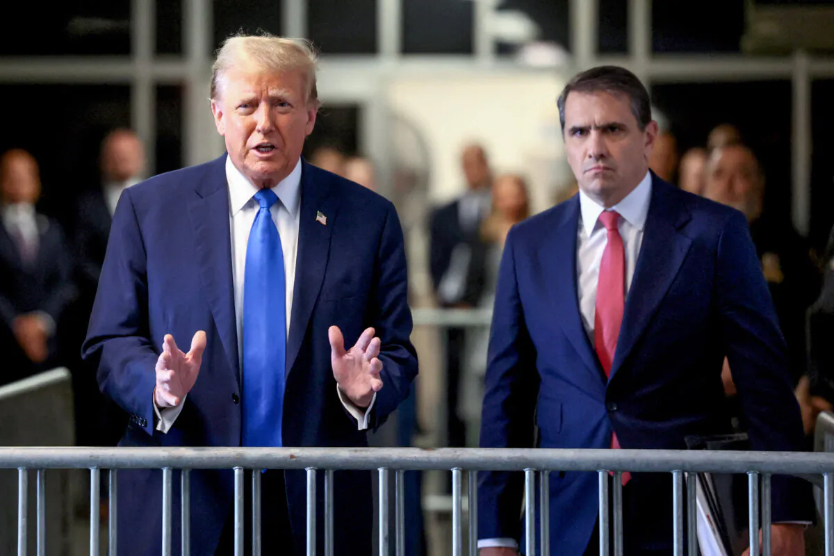 Former President and Republican presidential candidate Donald Trump, flanked by lawyer Todd Blanche (R), arrives at Manhattan Criminal Court to attend his trial for allegedly covering up hush money payments linked to extramarital affairs, in New York on April 22, 2024. (Brendan McDermid/Pool/AFP via Getty Images)