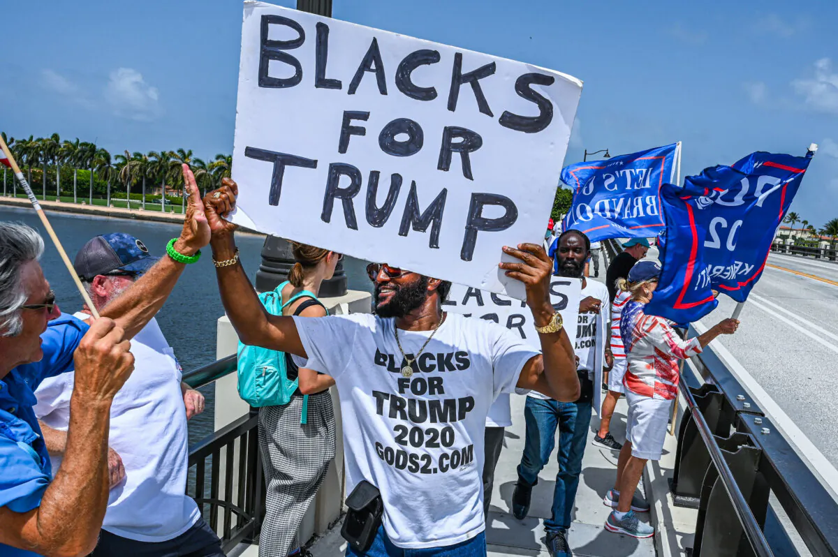 Supporters of former President Donald Trump walk near his residence at Mar-A-Lago in Palm Beach, Fla., on Aug. 9, 2022. (Giorgio Viera/AFP via Getty Images)